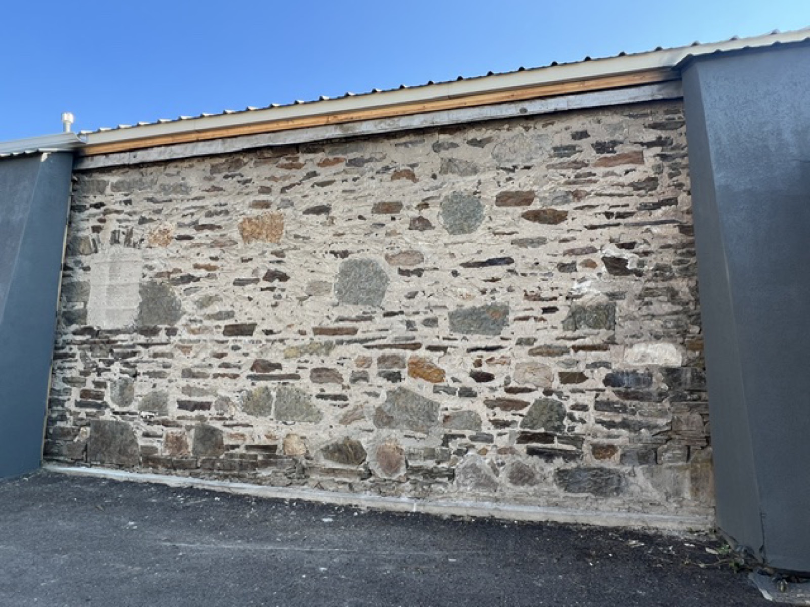 A wide stone bay between pillars, infilled