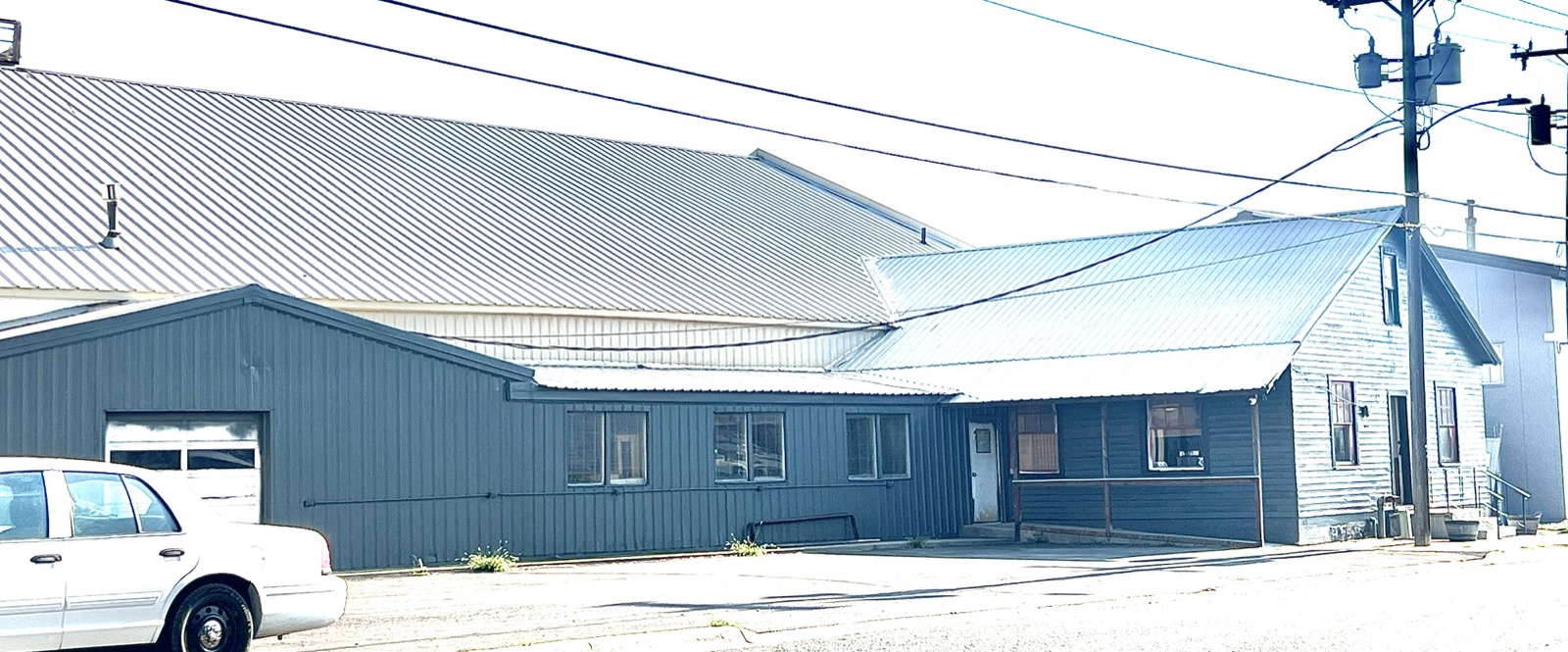 The office wing and metal-clad warehouse wall from the street