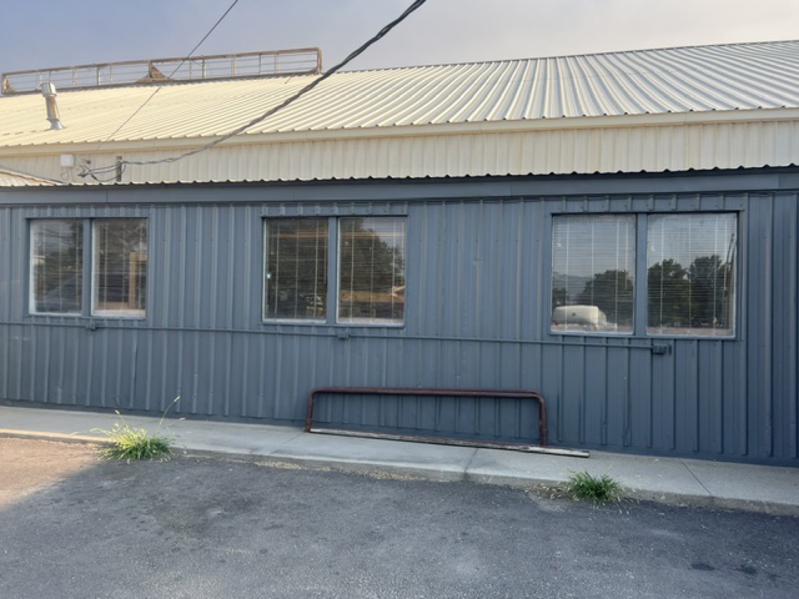 Dark metal side wall with three pairs of windows